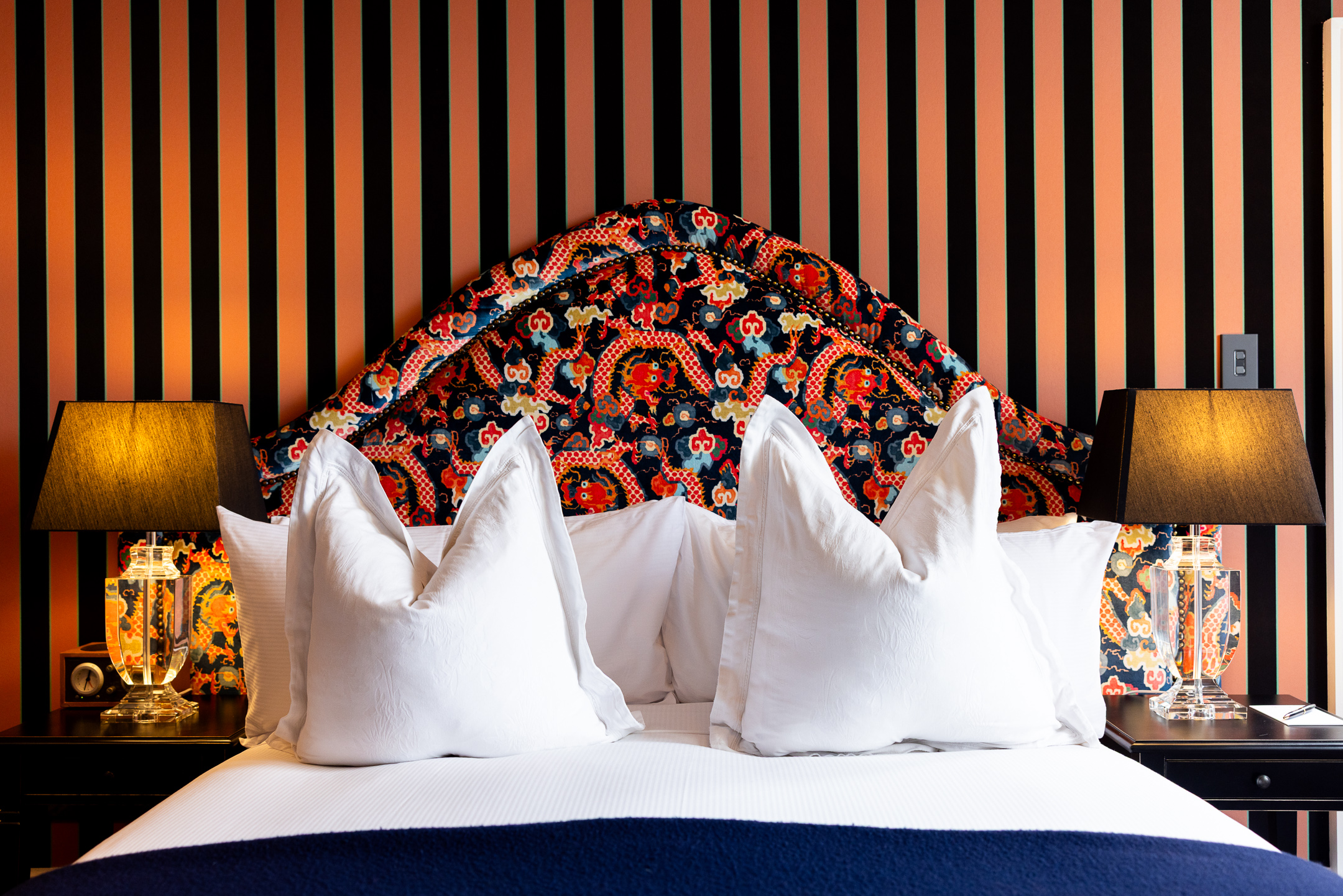 The detail of the padded decorative head board behind the Queen Bed in the McFarlane Room at Hulbert House