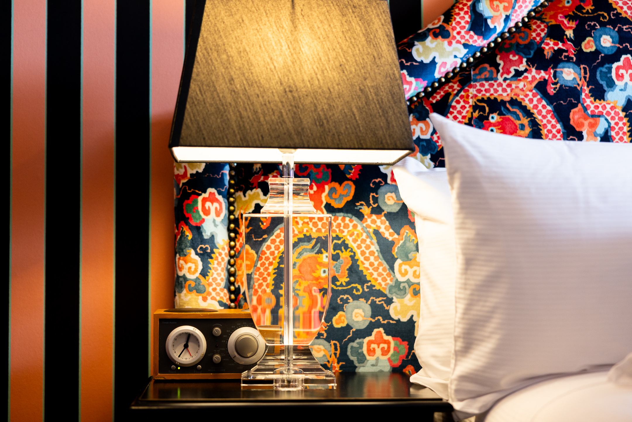 Bedside table light and clock amenities in the McFarlane Room at Hulbert House